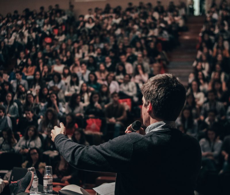 Image of man speaking to a large crowd